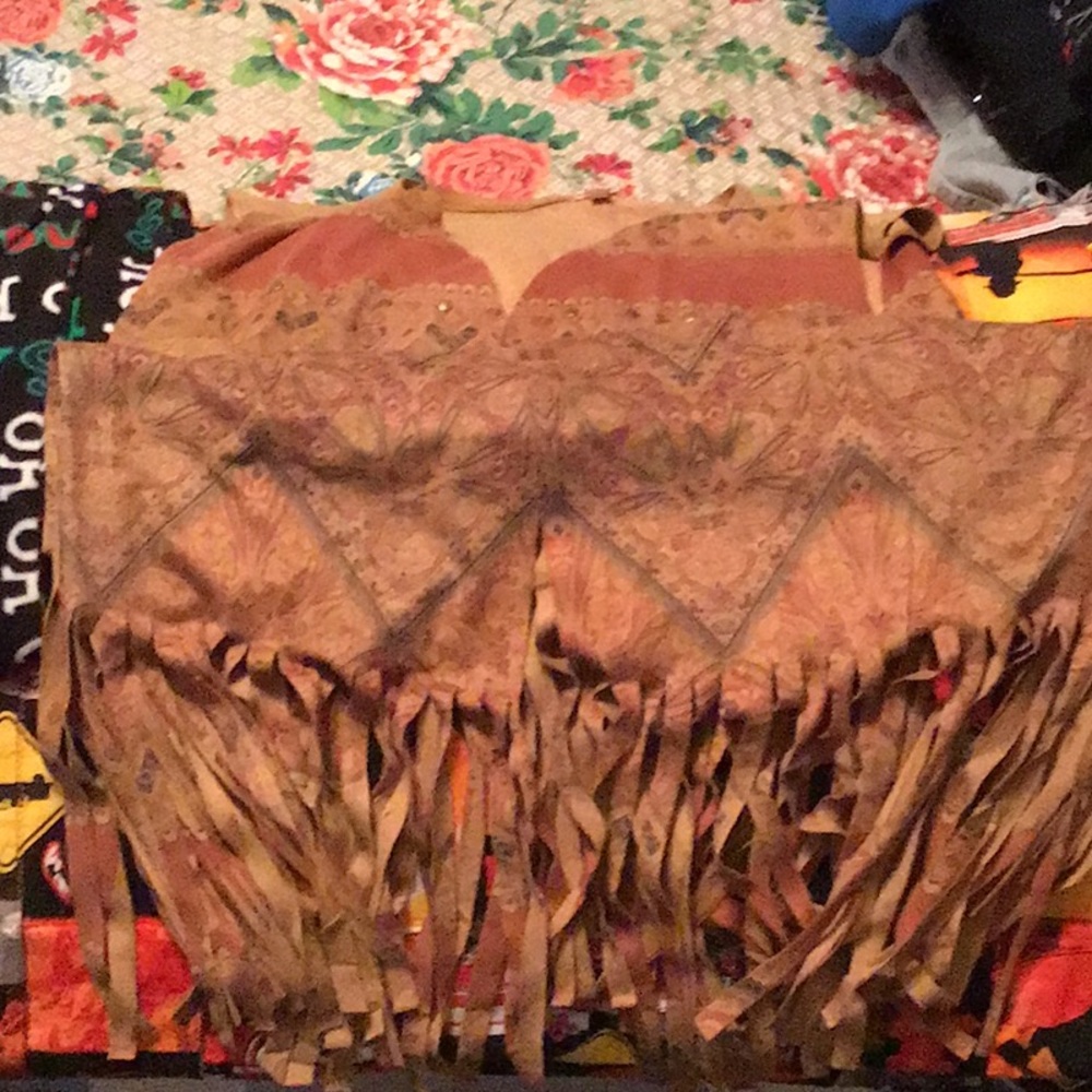 Waist length western vest with fringe.